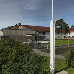 A fenced in yard with a house in the background