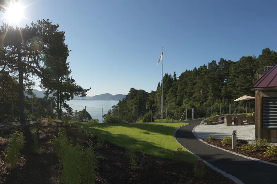 A path leading to a building and a body of water